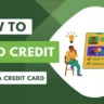 A person sitting on chair, looking at a screen. The screen shows a list of ways to build credit without a credit card, including getting a credit builder loan, secured credit card